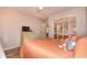 Bedroom with peach colored bedding and a dresser at 401 N Hillside Dr. # 3C, North Myrtle Beach, SC 29582