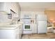 White kitchen features ample cabinetry and modern appliances at 401 N Hillside Dr. # 3C, North Myrtle Beach, SC 29582