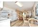 Open kitchen features white cabinets, and a view into the living room at 401 N Hillside Dr. # 3C, North Myrtle Beach, SC 29582