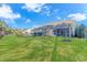 Backyard of home with screened porch and lush green lawn at 4348 Livorn Loop # 4348, Myrtle Beach, SC 29579