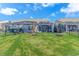 Backyard of home with a screened porch and green lawn at 4348 Livorn Loop # 4348, Myrtle Beach, SC 29579