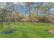 Landscaped backyard with grassy lawn and mature trees at 4348 Livorn Loop # 4348, Myrtle Beach, SC 29579