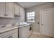 Laundry room with washer, dryer, cabinets and utility sink at 4417 N Plantation Harbour Dr. # B, Little River, SC 29566