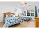 Guest bedroom with two twin beds, wood dresser, and large window at 4533 Girvan Dr. # D, Myrtle Beach, SC 29579