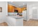 L-shaped kitchen with wood cabinets and white appliances at 4533 Girvan Dr. # D, Myrtle Beach, SC 29579