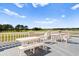 Outdoor patio with white tables, chairs, and benches overlooking a golf course at 4533 Girvan Dr. # D, Myrtle Beach, SC 29579