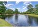 Serene pond with fountain, lush greenery, and landscaping at 4910 Windsor Green Way # 303, Myrtle Beach, SC 29579