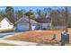 Gray siding house with a white garage door and red front door, landscaping, and driveway at 500 Cordgrass Ln., Little River, SC 29566