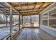 Screened porch with wood flooring and backyard view at 500 Cordgrass Ln., Little River, SC 29566