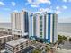 Aerial view of oceanfront resort; two towers, parking lot, and beach at 504 N Ocean Blvd. # 1511, Myrtle Beach, SC 29577
