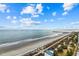 Oceanfront view of sandy beach with walkway and pier in the distance at 504 N Ocean Blvd. # 1511, Myrtle Beach, SC 29577