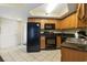 Kitchen with black appliances and wood cabinets at 504 N Ocean Blvd. # 1511, Myrtle Beach, SC 29577