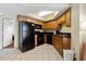 Well-equipped kitchen with black appliances and wood cabinets at 504 N Ocean Blvd. # 1511, Myrtle Beach, SC 29577