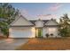 House exterior featuring a two-car garage and well-maintained lawn at 505 White Bark St., Longs, SC 29568