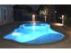 Lighted freeform pool at night, creating a tranquil ambiance at 5504 Via Verde Dr., North Myrtle Beach, SC 29582