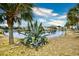 Landscaped pond view with palm trees and neighborhood homes at 5703 Coquina Point Dr., North Myrtle Beach, SC 29582