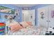 Bright bedroom with pastel blue walls, a vanity, and a flatscreen television displaying an ocean view at 688 Tattlesbury Dr., Conway, SC 29526
