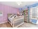 Colorful bedroom featuring a bed, shelf unit, and a window for natural light at 688 Tattlesbury Dr., Conway, SC 29526