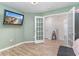 Bedroom featuring wood floors, a television, and a view into other rooms through French doors at 688 Tattlesbury Dr., Conway, SC 29526