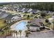 Aerial view of the community pool with palm trees, clubhouse, and neighborhood homes at 688 Tattlesbury Dr., Conway, SC 29526