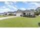 Beautiful one-story home boasts a lush green lawn in a well-maintained neighborhood at 688 Tattlesbury Dr., Conway, SC 29526