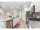 Open kitchen with granite countertops and stainless steel appliances overlooks the living area at 688 Tattlesbury Dr., Conway, SC 29526