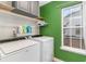 Laundry room with washer, dryer, overhead storage, and a window for natural light at 688 Tattlesbury Dr., Conway, SC 29526