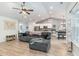 Open-concept living room featuring vaulted ceiling, fan, wood floors, with view of kitchen and dining area at 688 Tattlesbury Dr., Conway, SC 29526