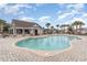 Community pool with a clubhouse, palm trees, lounge chairs, and neatly paved surrounding area at 688 Tattlesbury Dr., Conway, SC 29526