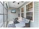 Cozy sunroom with neutral decor, TV, and great natural light for relaxing and entertaining at 688 Tattlesbury Dr., Conway, SC 29526