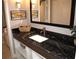 Bathroom with dark granite countertop and sink at 6900 N Ocean Blvd. # 111, Myrtle Beach, SC 29572
