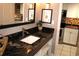 Bathroom with dark granite countertop and sink at 6900 N Ocean Blvd. # 111, Myrtle Beach, SC 29572