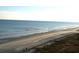 Beachfront property with people strolling along the shore at 6900 N Ocean Blvd. # 111, Myrtle Beach, SC 29572