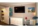Bedroom with white dresser, desk, and large TV at 6900 N Ocean Blvd. # 111, Myrtle Beach, SC 29572