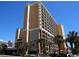 Oceanfront high-rise building with balconies and palm trees at 6900 N Ocean Blvd. # 111, Myrtle Beach, SC 29572