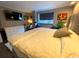 Main bedroom with king-size bed, large TV and dresser at 6900 N Ocean Blvd. # 111, Myrtle Beach, SC 29572
