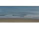 Stunning ocean view with calm waves lapping the shore at 6900 N Ocean Blvd. # 111, Myrtle Beach, SC 29572