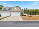 Tan two-story home with attached garage and landscaping at 763 Eastridge Dr., Conway, SC 29526