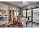 Bright dining area with table and chairs, view into bedroom and access to deck at 9661 Shore Dr. # 4B-15, Myrtle Beach, SC 29572