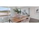 Dining area with wood table and view of pond through sliding glass doors at 1134 Black Lake Way, Conway, SC 29526