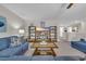 Bonus room features a sectional sofa, large TV, and built-in shelving at 1208 Maxwell Dr., Little River, SC 29566