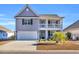 Two-story house with gray siding, white garage door, and landscaping at 1208 Maxwell Dr., Little River, SC 29566