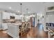Open concept kitchen with island, white cabinets, and stainless steel appliances at 1208 Maxwell Dr., Little River, SC 29566