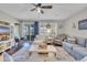 Bright living room with comfy sofas, a coffee table, and a view into the kitchen at 1208 Maxwell Dr., Little River, SC 29566