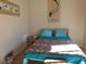 Bedroom with double bed, nightstand, and coastal art at 1210 Benna Dr. # B, Myrtle Beach, SC 29577