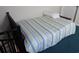 Small bedroom with a striped bedspread, and a view of a staircase at 1210 Benna Dr. # B, Myrtle Beach, SC 29577