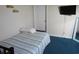 Small bedroom with a striped bedspread, TV, and mirror at 1210 Benna Dr. # B, Myrtle Beach, SC 29577