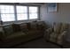 Living room with olive couch and striped armchair at 1210 Benna Dr. # B, Myrtle Beach, SC 29577