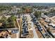 A high aerial view shows a neighborhood with a small pond and rows of neatly kept single Gathering homes at 160 Maggie Way, Myrtle Beach, SC 29588