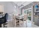An inviting dining room with a table set for six, featuring modern lighting and a sliding door to the outdoor space at 160 Maggie Way, Myrtle Beach, SC 29588